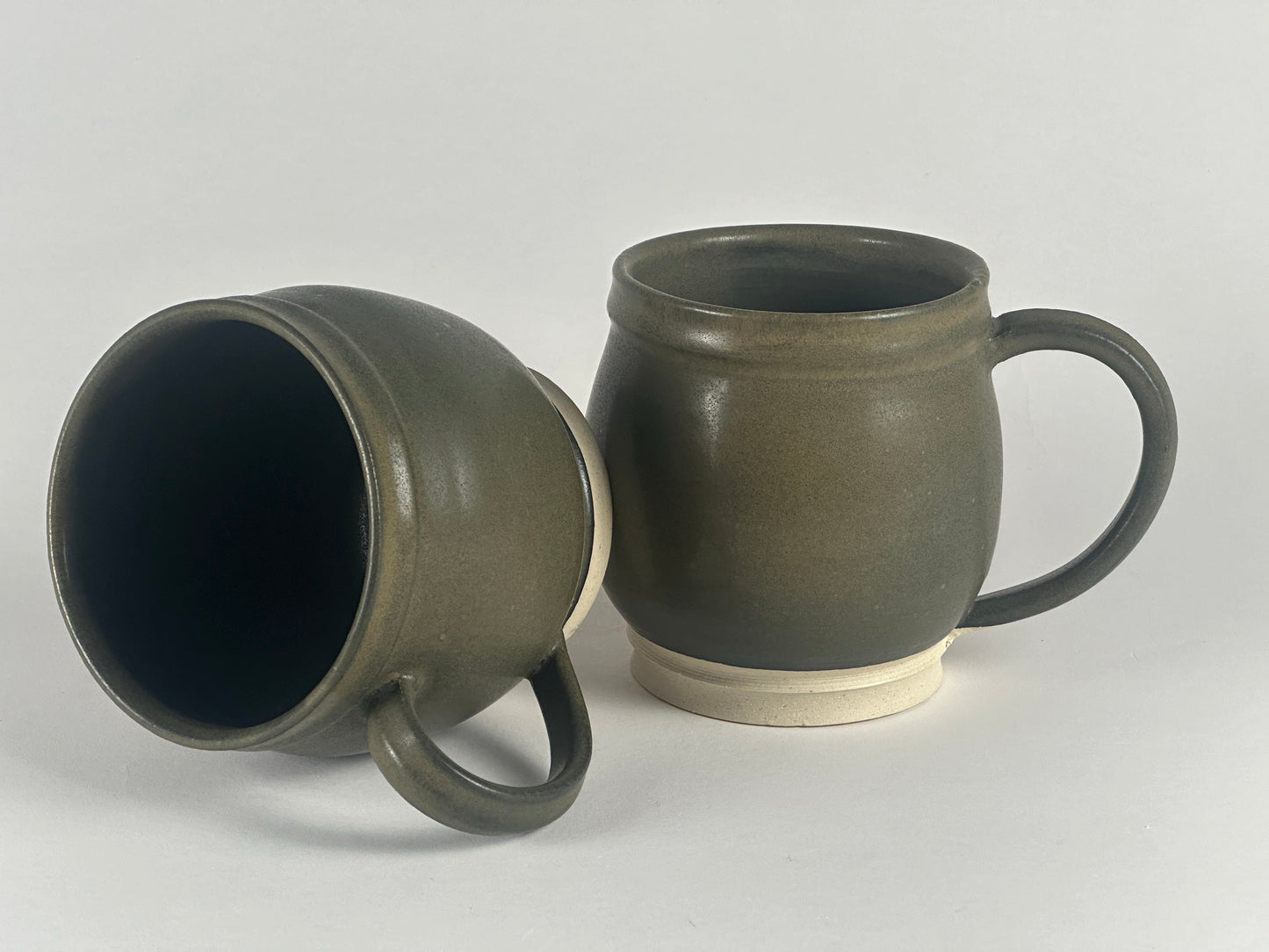 large round dark green mugs